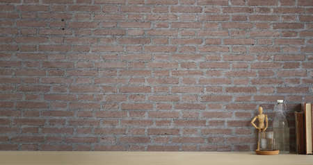 Minimal workspace with glass of water and books on white table with brick wall. Copy space for products display montage.の写真素材