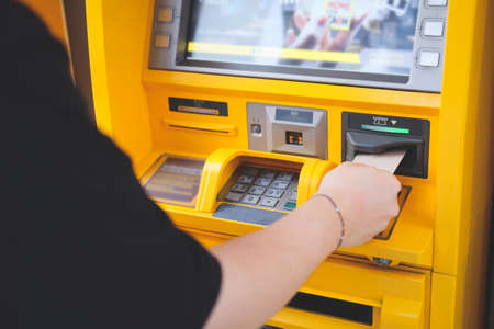 Close up view man using credit card to withdrawing money from Atm machineの写真素材