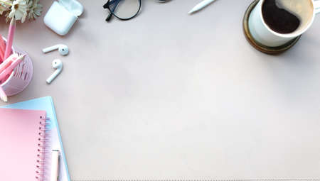 Simple workspace with up of coffee, glasses, earphones and notebook.の写真素材