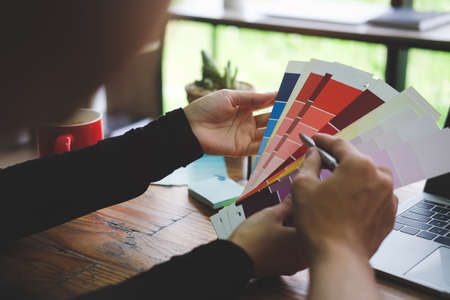 Close up view team of creative designer working together with colour swatch in office.の写真素材