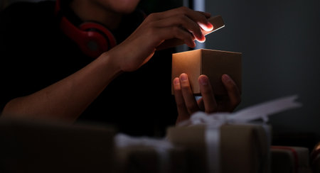 Man opening glowing Christmas present box.の写真素材