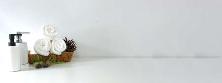 Shampoo bottles, cotton towels and aroma candle on white background.の写真素材