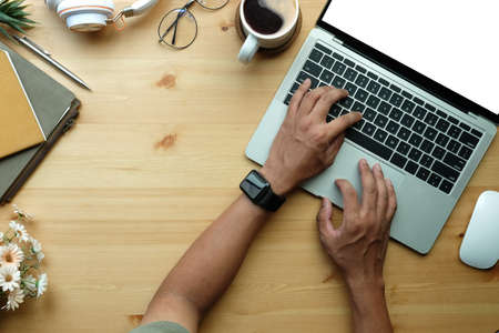Overhead view young man working with laptop computer.の写真素材