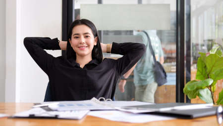 Asian businesswoman relaxing at office chair.