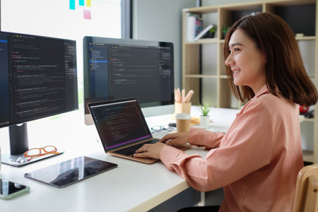 Asian female programmer working at at modern office. Developing programming.の写真素材