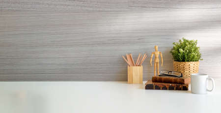 Modern workspace desk and copy space book, plant and coffee cup on wood desk.の写真素材