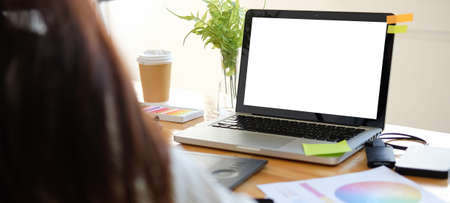 Over shoulder view of creative designer working with laptop computer at modern office.の写真素材
