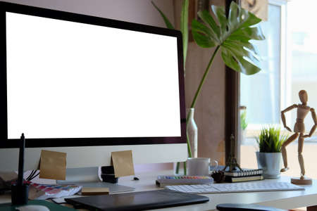 Creative workplace with modern computer, houseplant and supplies. Blank screen for graphic display...