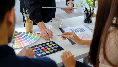 Group of young creative coworkers working with new startup project together in office.の写真素材