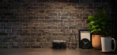 Stylish workspace with camera, houseplant, picture frame and coffee cup on wooden table. Copy space for text.の写真素材