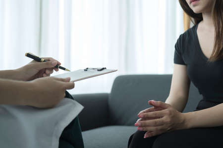 Female patient having consultation with psychiatrist in medical clinic. Mental health Conceptの写真素材