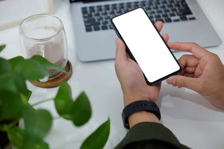 Close up view businessman hands holding smart phone. Blank screen for your text or information...