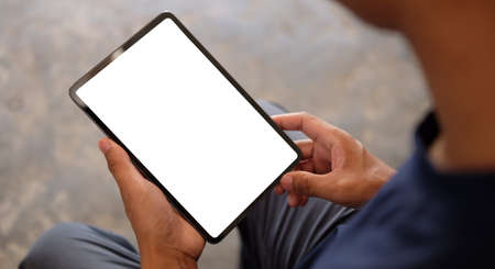 Young man using digital tablet. Blank screen for your text.