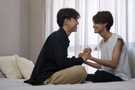 Happy gay couple holding hands each other. Symbol of the LGBT community, equal rights, beauty and love.の写真素材