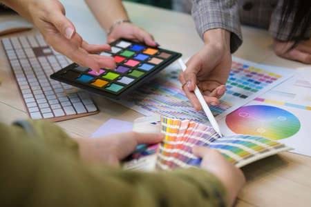 Close up view group of creative people working on new project together.の写真素材