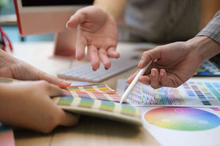 Professional team of interior designers brainstorming and discussing ideas together at creative office.の写真素材