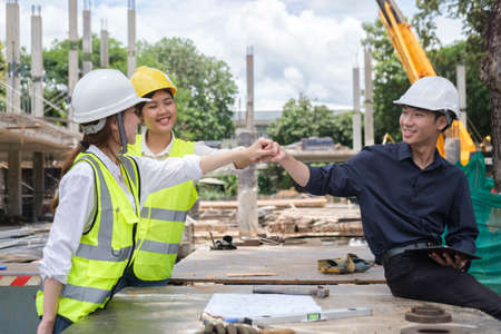 Professional engineer team making fist bump together to celebrating after success project or showing team spirit.の写真素材