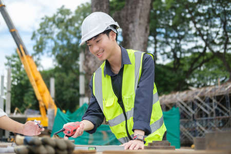 Smart civil engineer manager wearing safety helmet and vast  inspecting and working at structure...