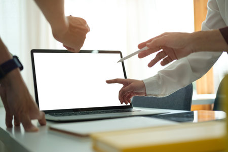 Cropped image of businesspeople hands pointing on laptop screen. Blank screen for your advertise tex.の写真素材
