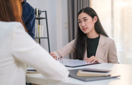 Focused professional business team working together discuss paperwork corporate plan at meeting table.の写真素材
