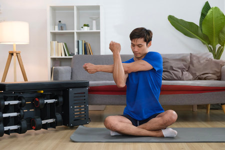 Portrait of active millennial man doing morning workout at home. Sporty lifestyle and bodybuilding...
