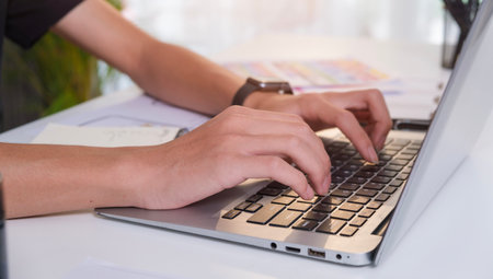 Close up view of creative man hands typing on laptop computer. Freelance work, technology and...