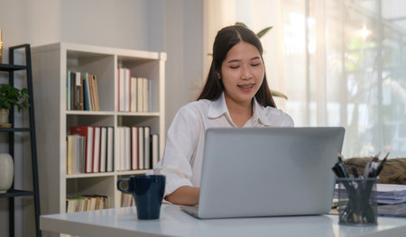 Young businesswoman manager watching online webinar training or having virtual meeting video conference on laptop computer.の写真素材