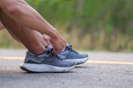 Sporty asian male tying shoelace, prepare exercise in the morning.