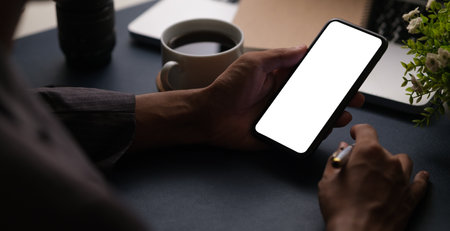 Man hands holding smart phone with blank screen for your text message or information content.の写真素材