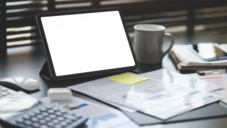 Business graphs, charts, digital tablet and calculator on office desk. Financial development, banking account and statistics.の写真素材