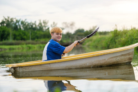Smiling man tourists rowing boat  on the river.ravel, vacation holiday and outdoor activity.の写真素材