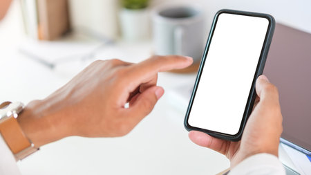 Man hands holding smart phone with blank screen for your text message or information content.の写真素材