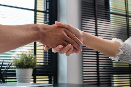 Business people shaking hands in office finishing up a meeting.  Partnership, recruitment or job interview.の写真素材