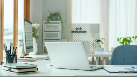 Modern workplace with laptop computer ,pencil holder and notebook on white table.の写真素材