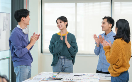 Team of ux developer brainstorming and discussing about mobile app wireframe design at modern workplace.の写真素材