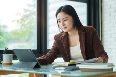 Portrait of businesswoman holding digital tablet in modern office.の写真素材