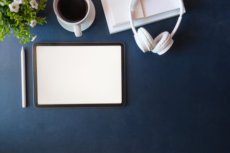 Top view office desk with digital tablet, coffee cup and notebook.の写真素材