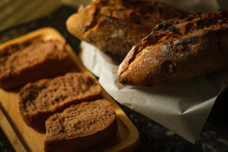 Freshly baked bread on a wooden board. Selective focus.