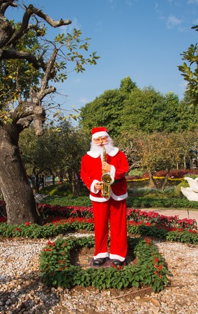 Santa statue holding  Saxophone in garden Chiangrai Province,Thailand.の写真素材
