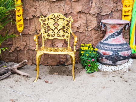 Chair  with jar in garden on dry leaf of largh timber tree.の写真素材
