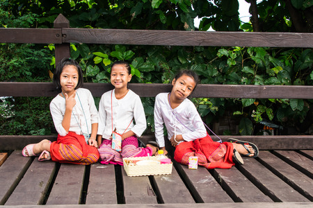 SANGKLABURI THAILAND JULY 19 :Unidentified portrait cute  girls sit on wooden bridge or Mon bridge on July 19, 2016  Sangklaburi Kanjanaburi Thailand.のeditorial素材