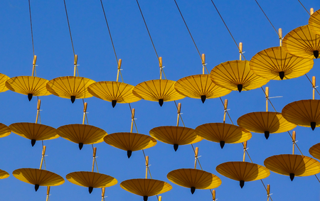 Yellow umbrella hanging on rope,Decoration in garden at flower festival 2017 in Chiangmai city Thailand.の写真素材