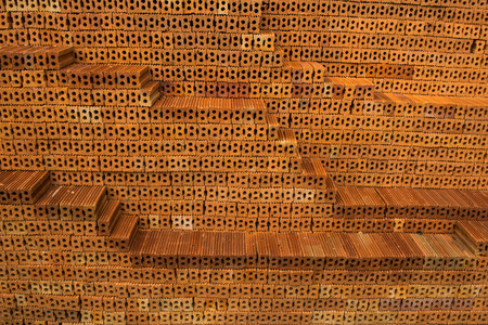 New brown bricks on construction site.