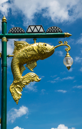 Street lamp golden fish beautiful Isolated on blue sky background.の写真素材