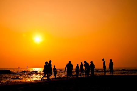 Kids group silhouette with activities on the beachの写真素材