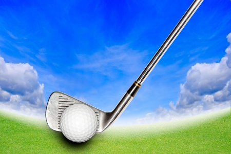 Golf Stick and Ball on the Green Grass and Blue Skyの写真素材