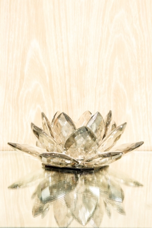 Candle holder refletion on glass base with wood backgroundの写真素材