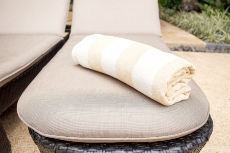Towels on relaxing of sun beds at swimming poolの写真素材
