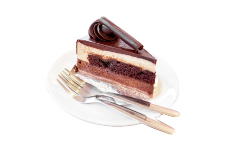 Piece of chocolate cake with icing isolated on white backgroundの写真素材