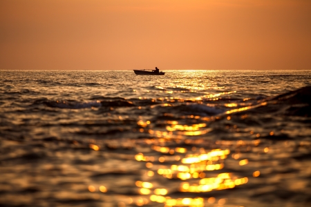 Fisherman silhouette on sunrise, Thailandの写真素材